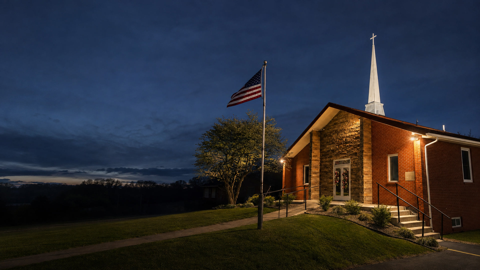 Eastland First Church of God at blue hour with its white steeple and cross